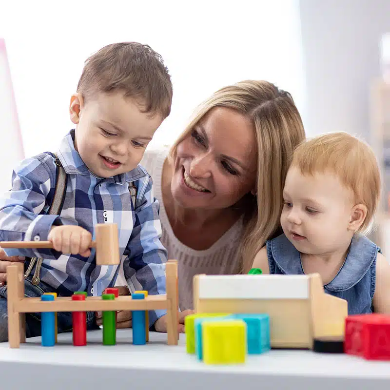 Teacher helping kids with educational toys